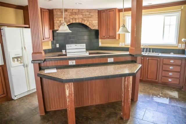 kitchen featuring a kitchen island, white refrigerator with ice dispenser, tasteful backsplash, sink, and hanging light fixtures