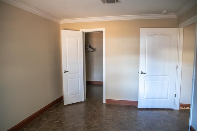 unfurnished bedroom with a closet and crown molding