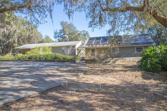 view of front facade with solar panels