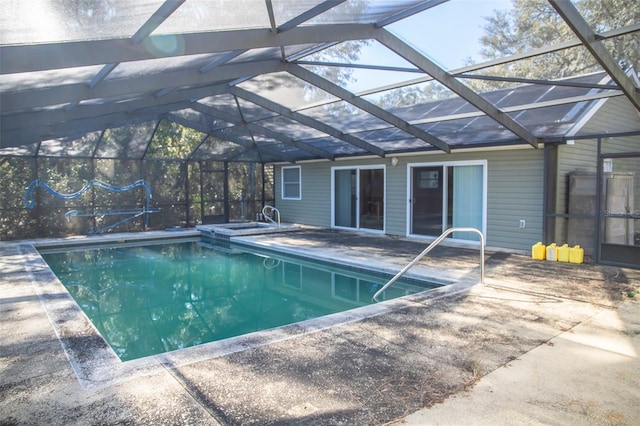 view of pool featuring glass enclosure and a patio