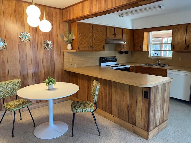 kitchen with sink, hanging light fixtures, kitchen peninsula, white dishwasher, and electric range