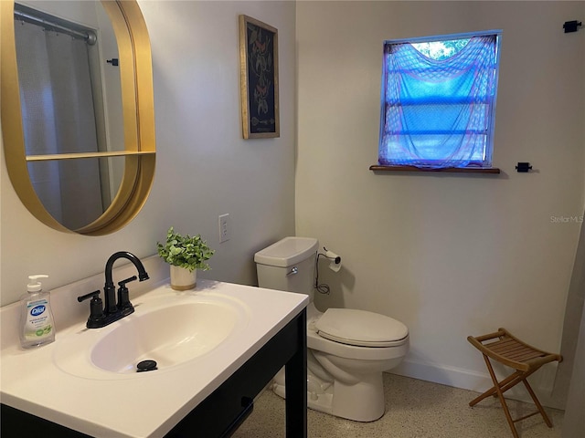 bathroom with toilet and vanity