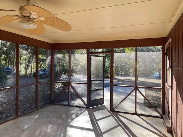 unfurnished sunroom featuring ceiling fan