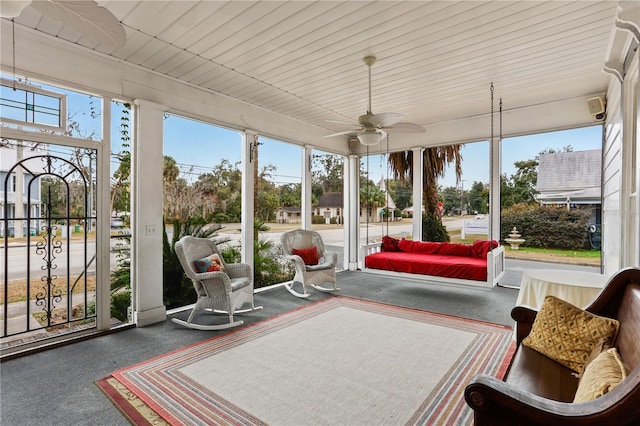 sunroom / solarium featuring ceiling fan and a healthy amount of sunlight