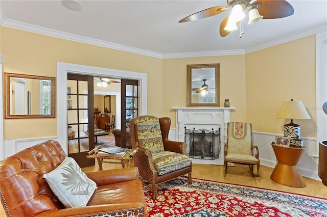 sitting room with crown molding, french doors, ceiling fan, and hardwood / wood-style flooring