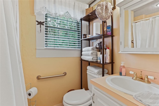 bathroom featuring vanity, toilet, and a shower with shower curtain