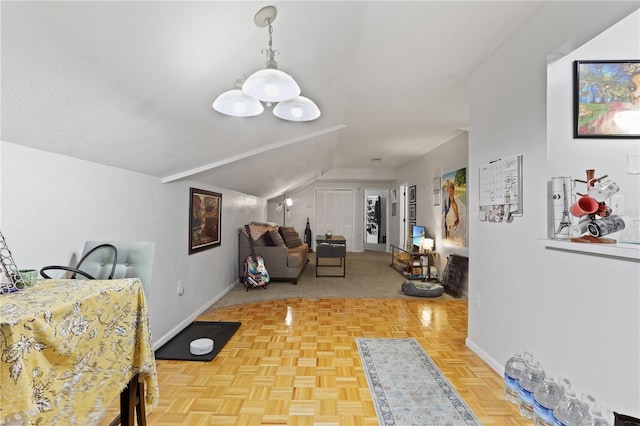 dining room featuring parquet floors and lofted ceiling