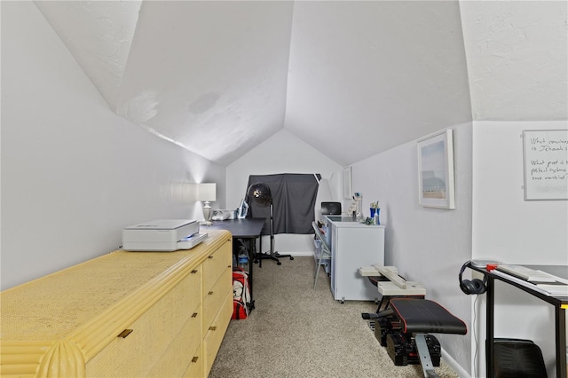 carpeted office featuring vaulted ceiling