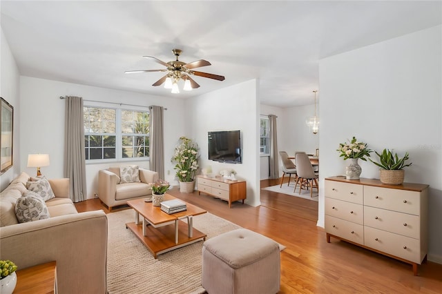 living room featuring light hardwood / wood-style flooring and ceiling fan