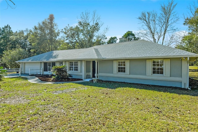 single story home with a garage and a front lawn