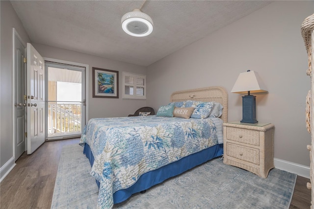 bedroom featuring hardwood / wood-style flooring and a textured ceiling