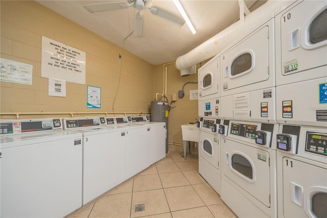 laundry room with light tile patterned flooring, stacked washer and dryer, ceiling fan, washing machine and dryer, and electric water heater