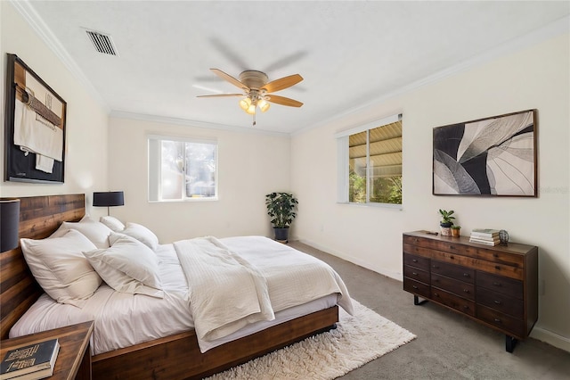 carpeted bedroom with multiple windows, ornamental molding, and ceiling fan