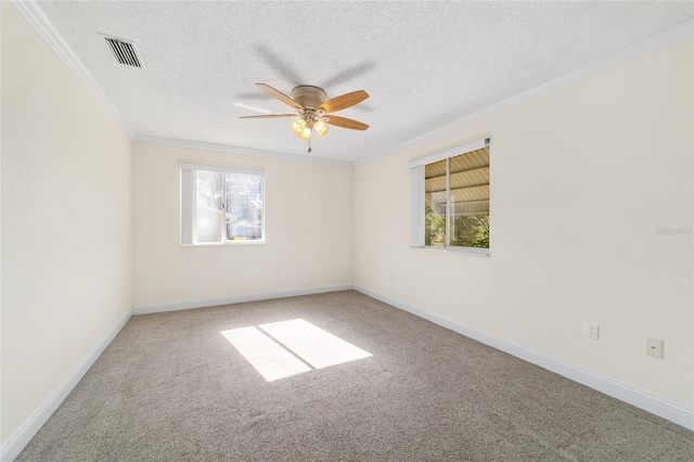 empty room with ornamental molding, a textured ceiling, and carpet flooring