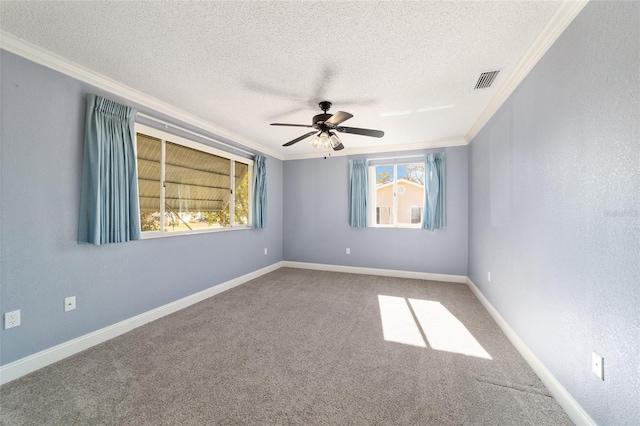 spare room featuring ornamental molding, carpet flooring, a textured ceiling, and ceiling fan