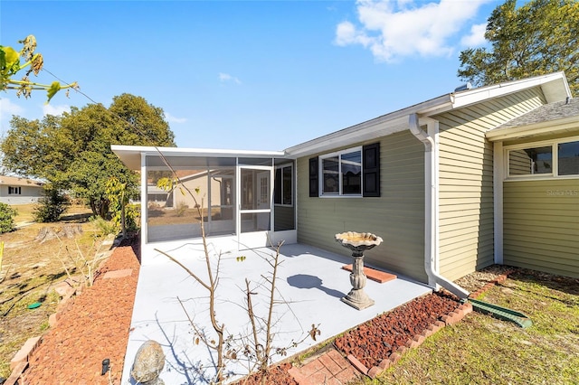 back of property featuring a patio area and a sunroom