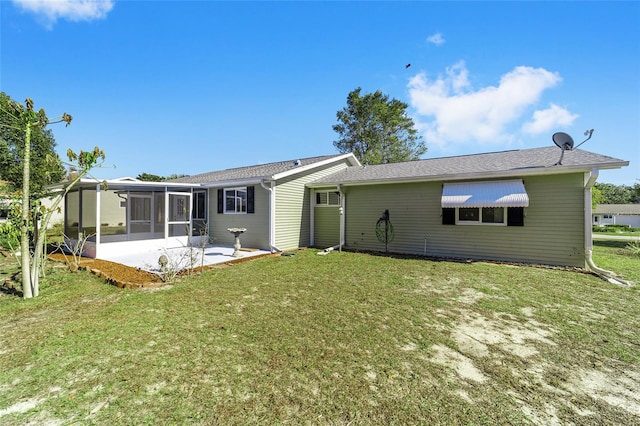 back of property with a sunroom and a lawn