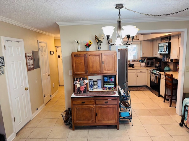 kitchen featuring crown molding, appliances with stainless steel finishes, hanging light fixtures, light tile patterned flooring, and a chandelier