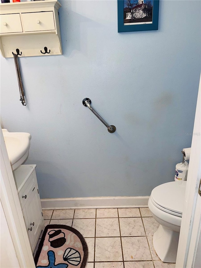 bathroom with vanity, toilet, and tile patterned flooring