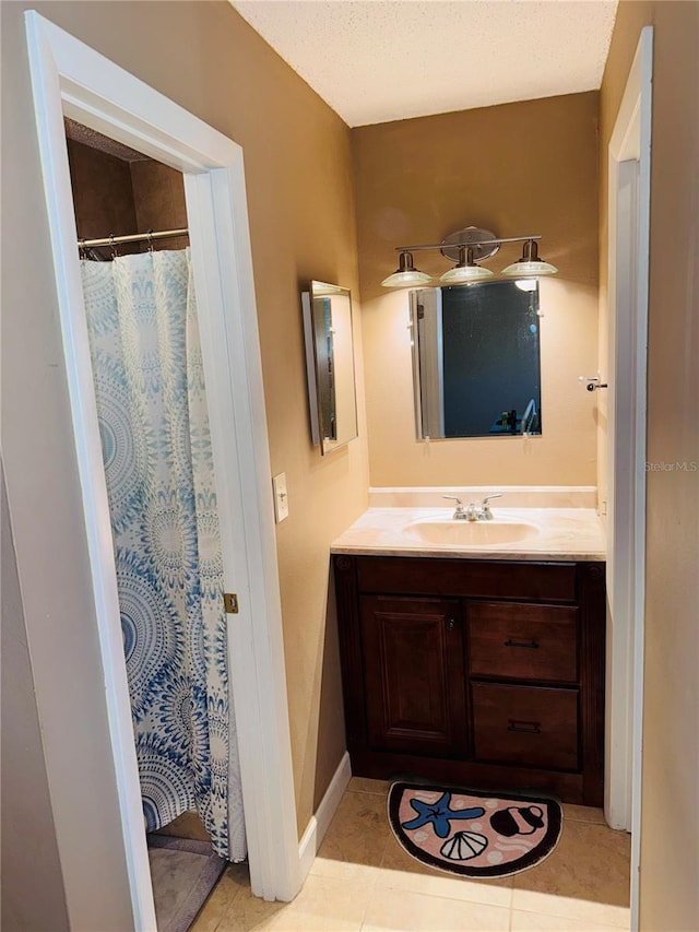 bathroom with vanity, tile patterned floors, a textured ceiling, and a shower with shower curtain