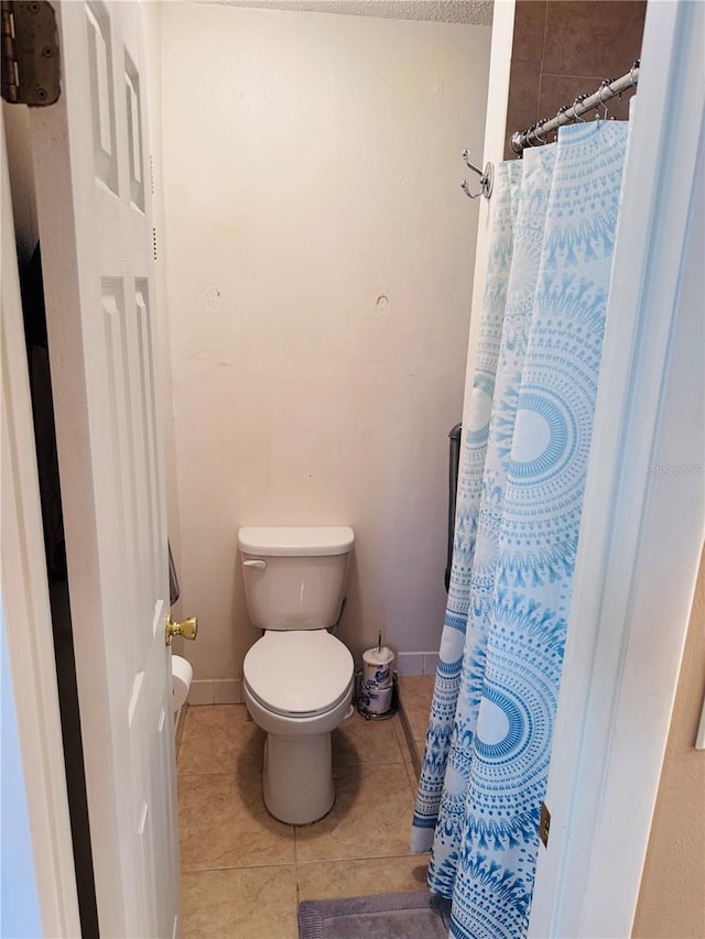 bathroom featuring tile patterned flooring and toilet