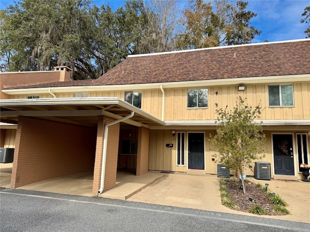 view of front of house with central AC and a carport