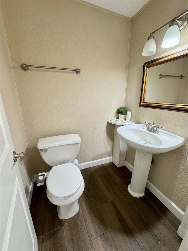 bathroom with wood-type flooring and toilet