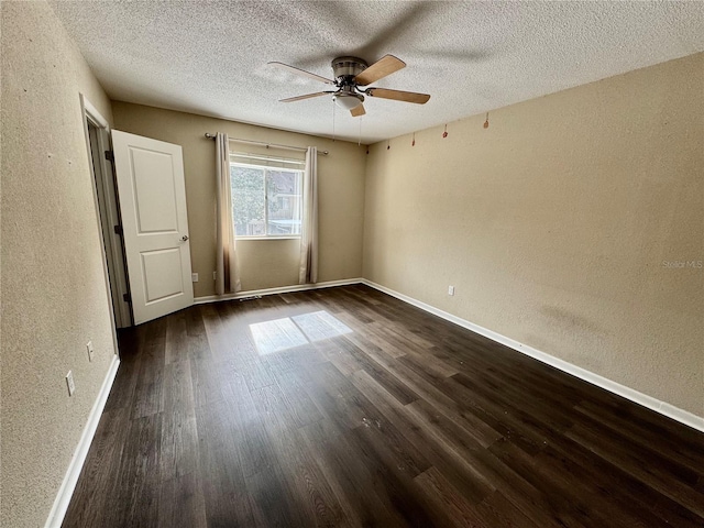 unfurnished room with ceiling fan, dark hardwood / wood-style flooring, and a textured ceiling