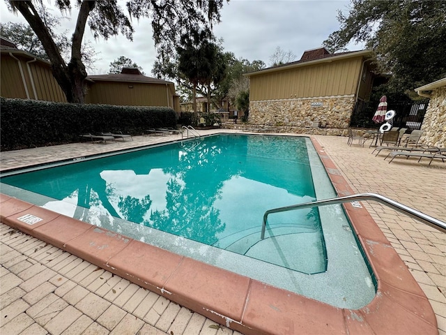 view of swimming pool with a patio