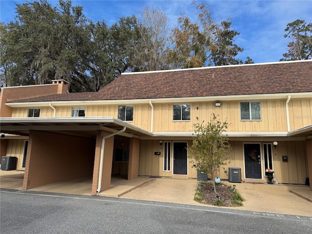 view of front of property with cooling unit and a carport