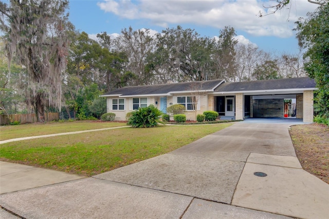 ranch-style home featuring a carport, a garage, and a front yard