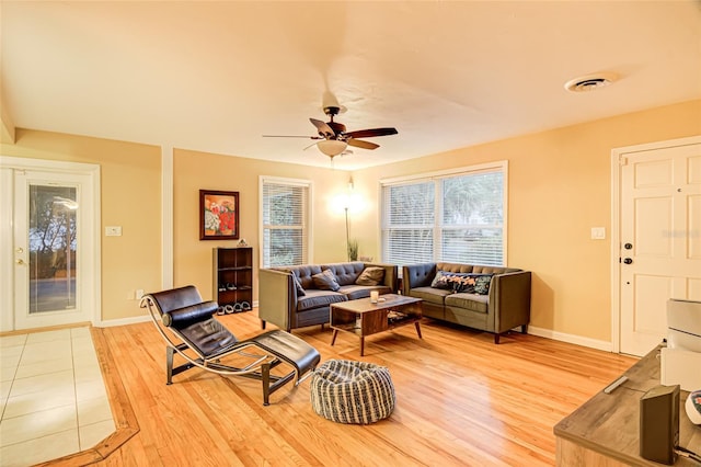 living room featuring hardwood / wood-style floors and ceiling fan