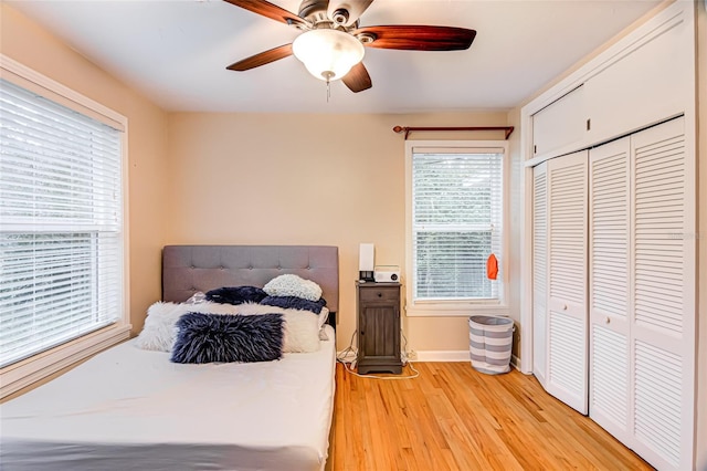 bedroom featuring light hardwood / wood-style floors, a closet, and ceiling fan