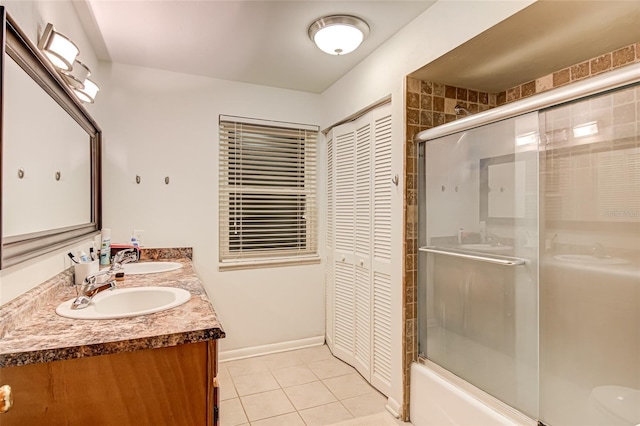 bathroom with tile patterned flooring, vanity, and enclosed tub / shower combo