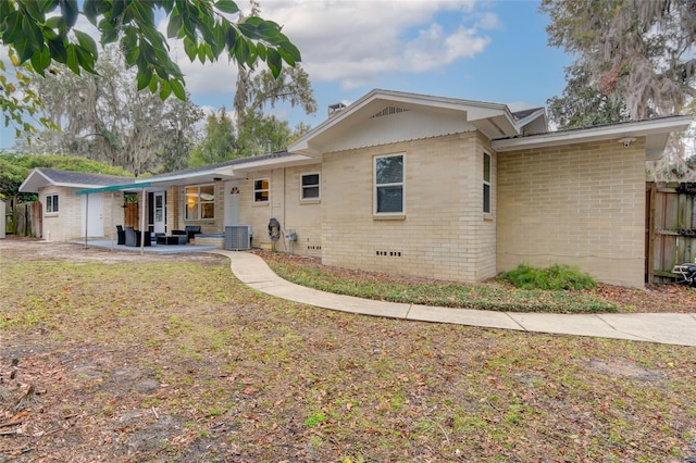 back of property featuring a patio and central air condition unit