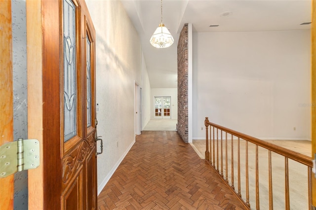 corridor featuring parquet flooring and a chandelier