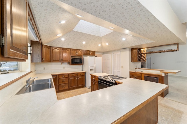 kitchen with lofted ceiling with skylight, sink, electric range, kitchen peninsula, and white fridge with ice dispenser