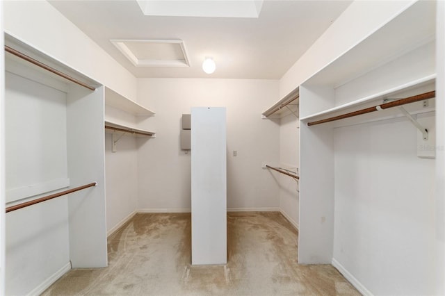 walk in closet featuring light colored carpet