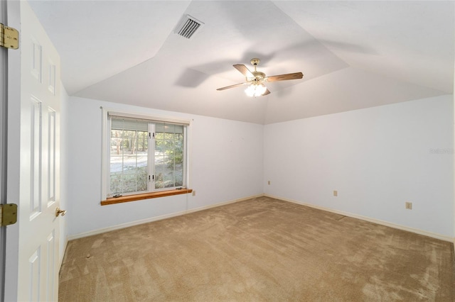 carpeted empty room with ceiling fan and vaulted ceiling