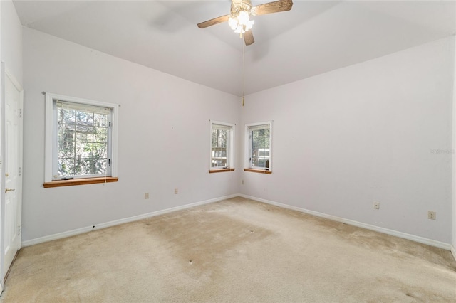 carpeted empty room featuring ceiling fan and high vaulted ceiling