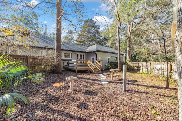 rear view of property with a wooden deck