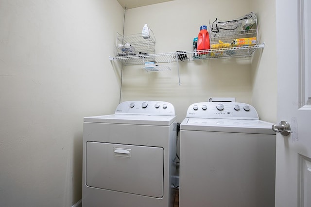 laundry room with washing machine and clothes dryer