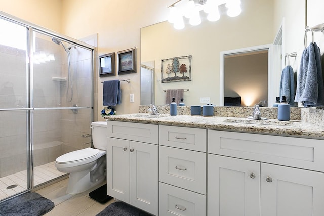 bathroom featuring vanity, tile patterned floors, a shower with door, and toilet