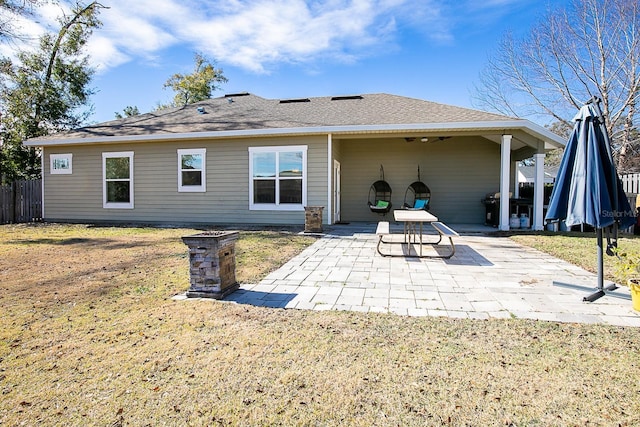 back of property with a patio and a lawn