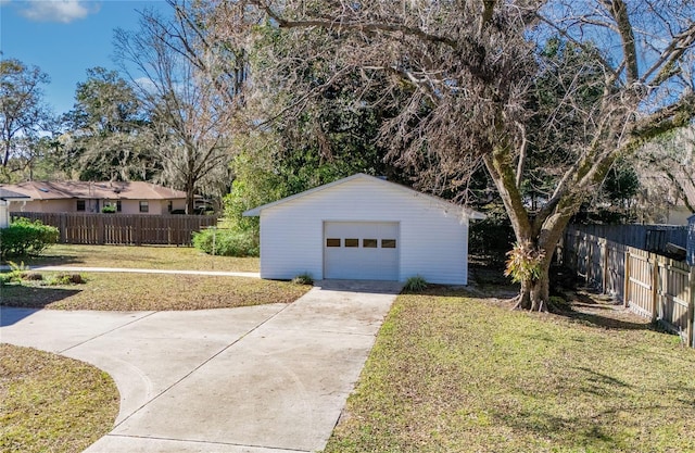 detached garage with driveway and fence