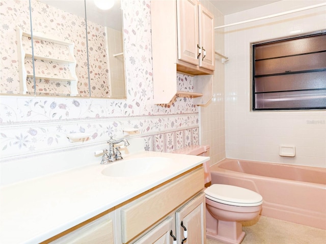 bathroom featuring toilet, vanity, wallpapered walls, and bathing tub / shower combination