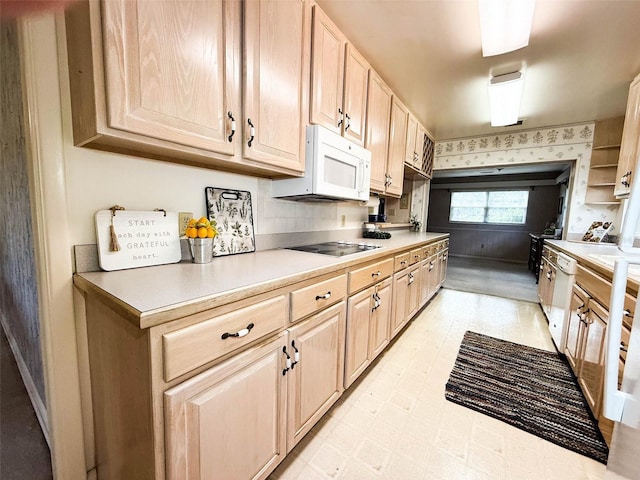 kitchen with light countertops, light brown cabinets, and white appliances