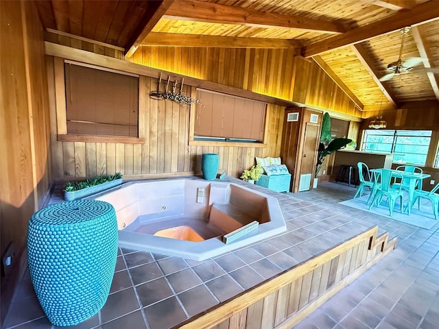 interior space with a jacuzzi, wood walls, a ceiling fan, beamed ceiling, and wood ceiling