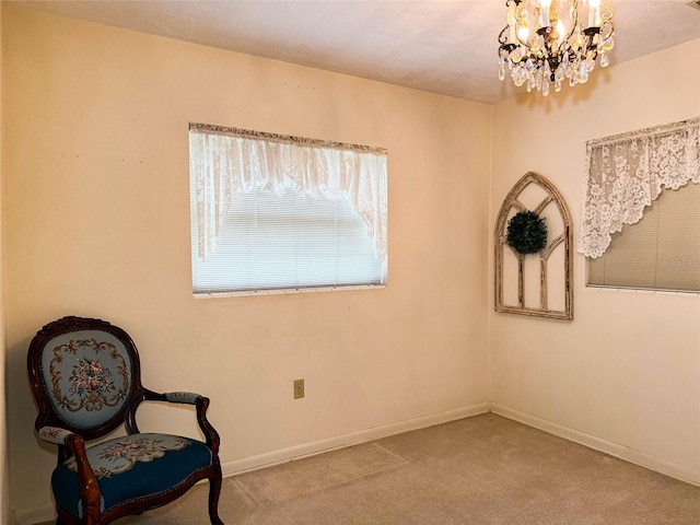living area with baseboards, carpet flooring, and a notable chandelier