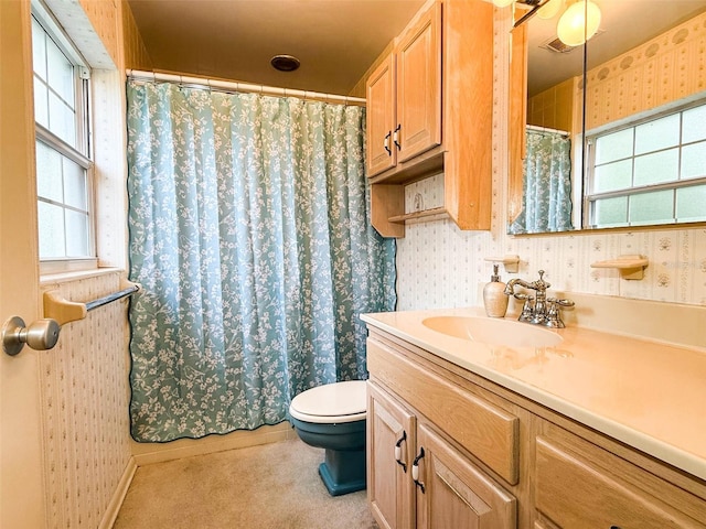 bathroom with a wealth of natural light and wallpapered walls